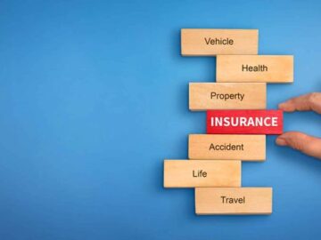hand holding a wooden block with text insurance, different types